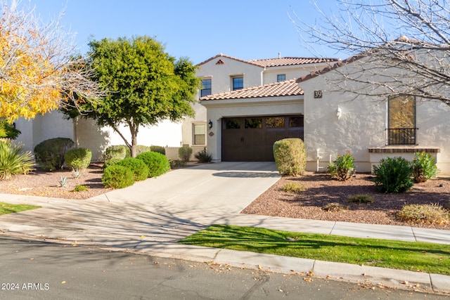 mediterranean / spanish house with a garage