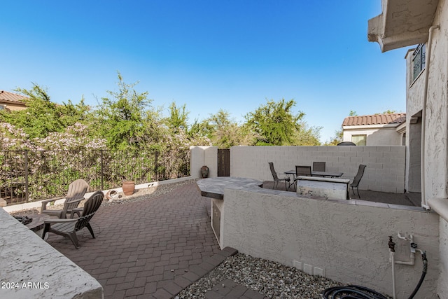 view of terrace with an outdoor fire pit