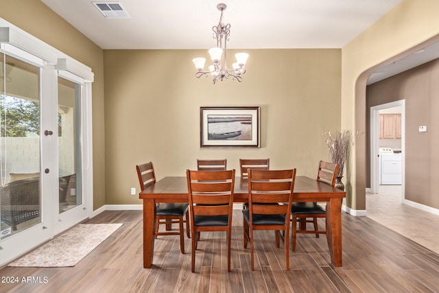 dining space with a chandelier and tile flooring