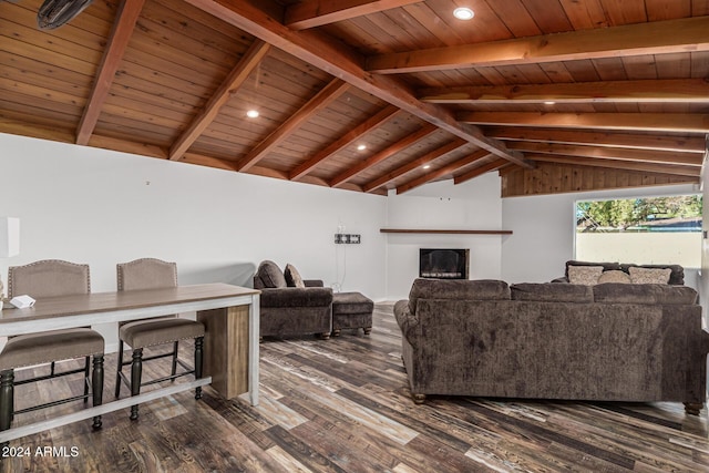 living room with dark wood finished floors, lofted ceiling with beams, a fireplace, and wooden ceiling