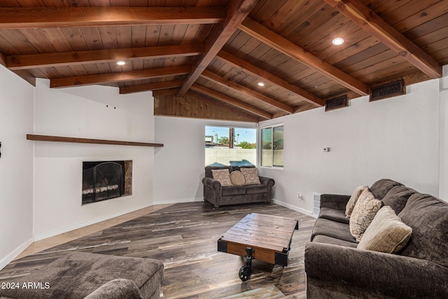 living area featuring visible vents, vaulted ceiling with beams, baseboards, a fireplace, and wood finished floors