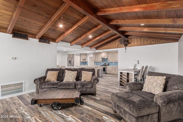 living area featuring visible vents, vaulted ceiling with beams, and light wood-style floors