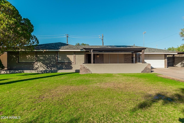 single story home featuring a front yard, an attached garage, concrete driveway, and stucco siding