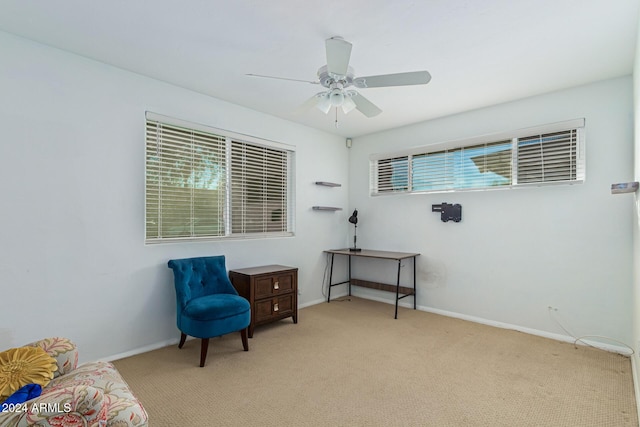 living area with baseboards, carpet floors, and ceiling fan