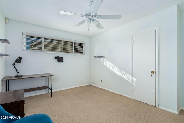 interior space with a ceiling fan, carpet, and baseboards