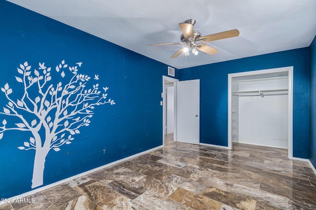 unfurnished bedroom featuring visible vents, marble finish floor, a ceiling fan, a closet, and baseboards