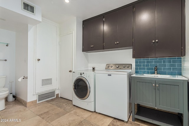 laundry area featuring laundry area, washing machine and dryer, visible vents, and a sink