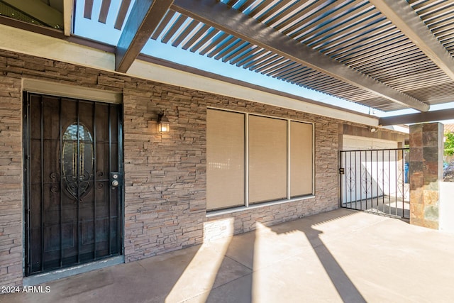 exterior space featuring a gate and a pergola