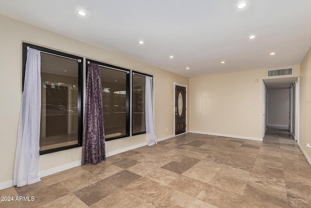 unfurnished room with recessed lighting, visible vents, and baseboards