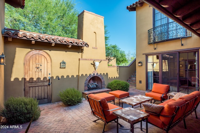 view of patio featuring an outdoor living space with a fireplace