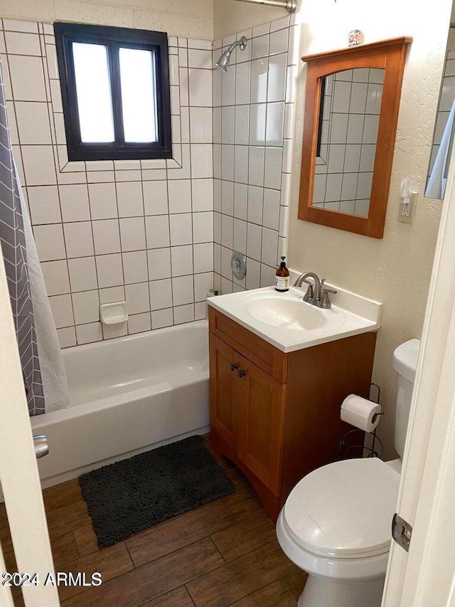 full bathroom with shower / tub combo, vanity, hardwood / wood-style flooring, and toilet