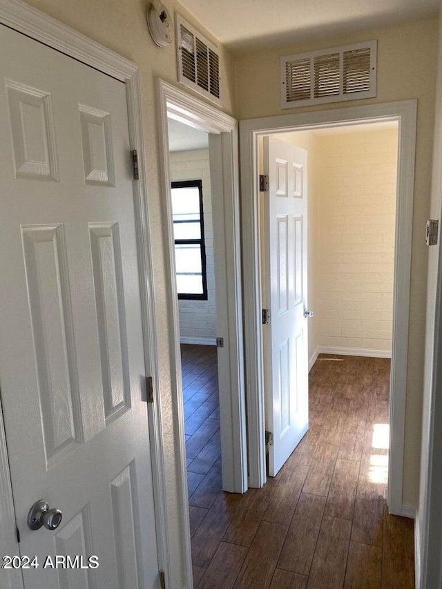 corridor with dark hardwood / wood-style flooring