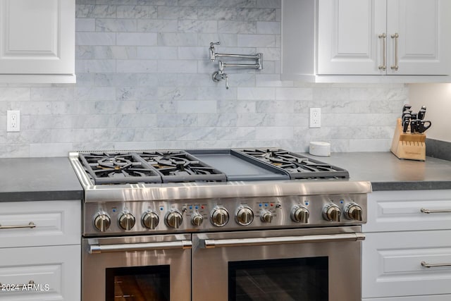 kitchen with decorative backsplash, white cabinets, and double oven range