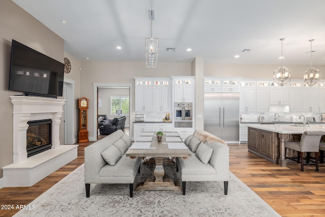 living room with light hardwood / wood-style flooring and sink