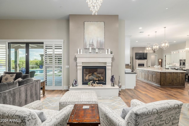 living room featuring a notable chandelier and light hardwood / wood-style flooring