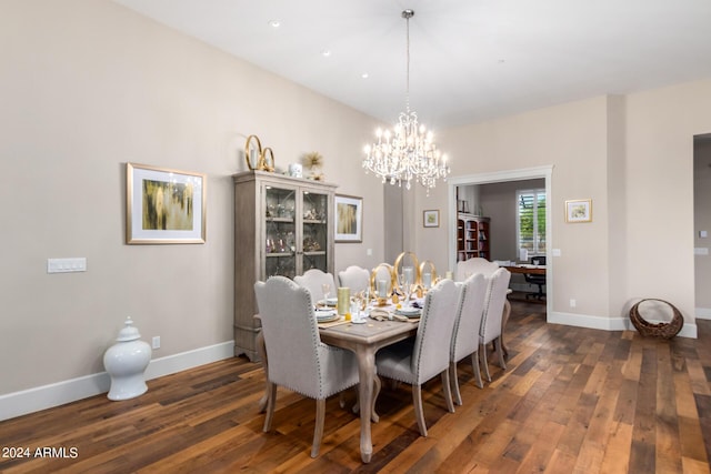 dining space featuring dark hardwood / wood-style flooring and an inviting chandelier