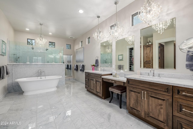 bathroom with vanity, separate shower and tub, plenty of natural light, and an inviting chandelier