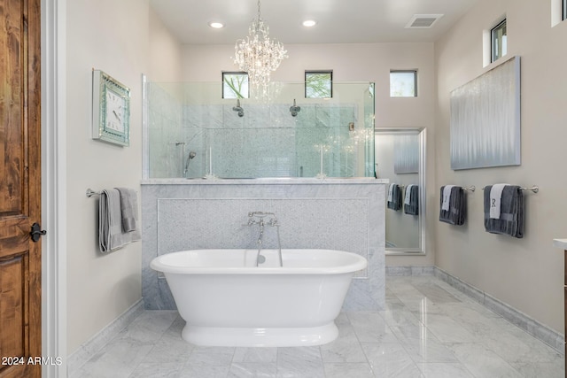 bathroom with separate shower and tub and an inviting chandelier