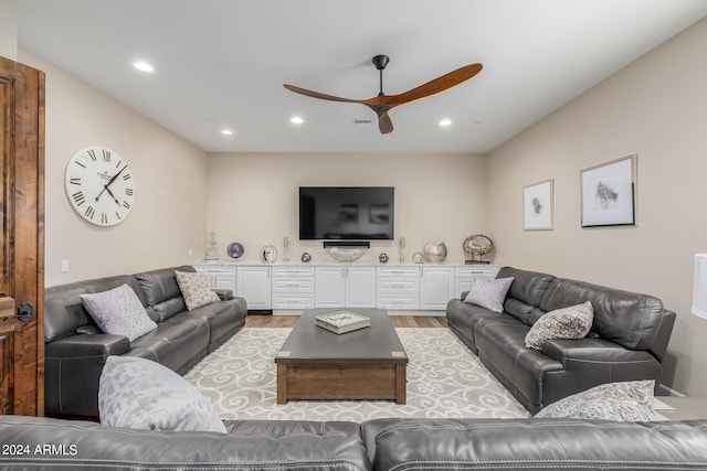 living room featuring light wood-type flooring and ceiling fan