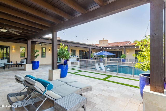 view of patio featuring a fenced in pool, outdoor lounge area, and ceiling fan