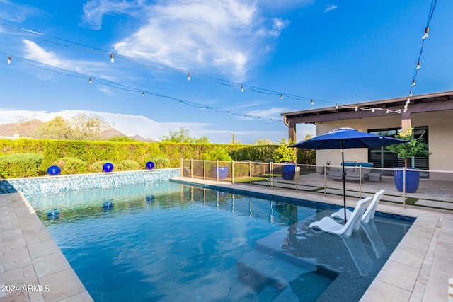 view of swimming pool featuring a mountain view and a patio