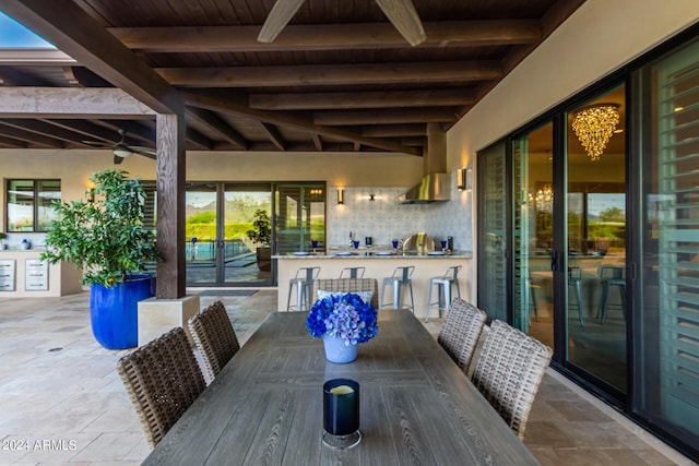 exterior space featuring ceiling fan and a bar