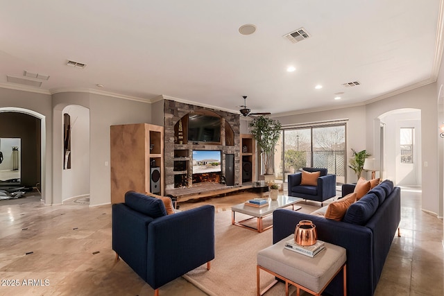 living room with ornamental molding, ceiling fan, and a fireplace