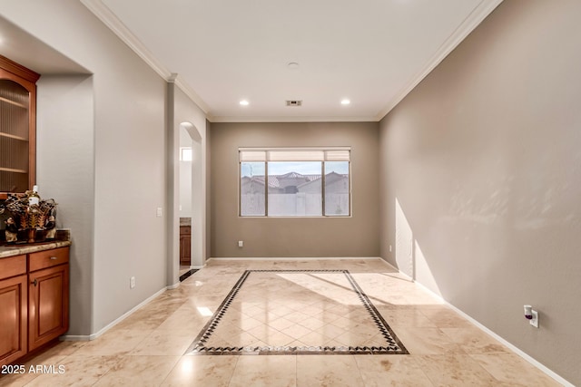 empty room featuring crown molding