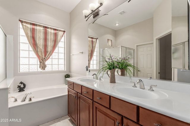 bathroom with vanity, a bathing tub, and tile patterned flooring