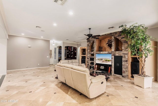 living room featuring crown molding, a large fireplace, and ceiling fan