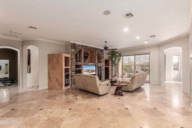 living room with crown molding, a fireplace, and ceiling fan