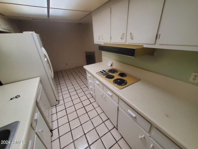 kitchen featuring white cabinetry, light countertops, and white appliances