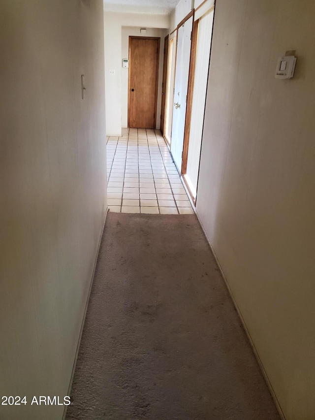 corridor featuring light tile patterned floors