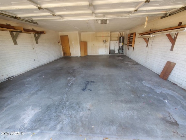 garage with gas water heater and a garage door opener