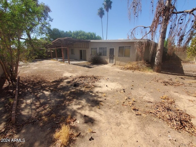 view of front of house with stucco siding and a patio