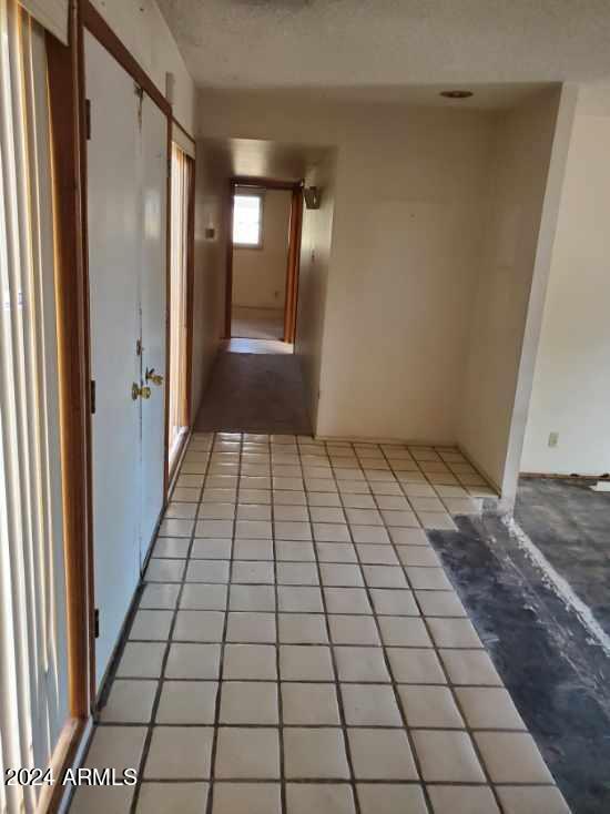 corridor featuring light tile patterned floors