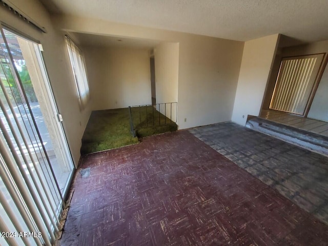 unfurnished living room with a textured ceiling