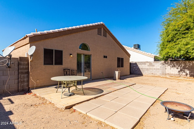 back of house featuring central air condition unit and a patio