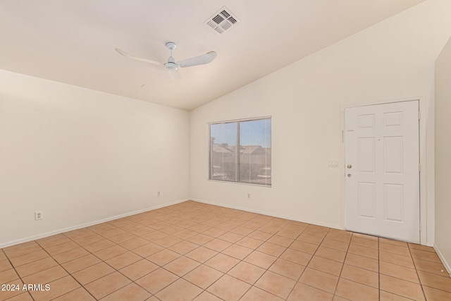 unfurnished room with ceiling fan, light tile patterned floors, and vaulted ceiling