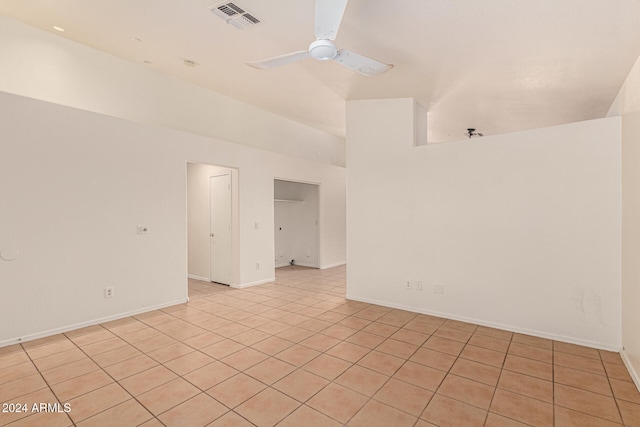 tiled spare room with high vaulted ceiling and ceiling fan