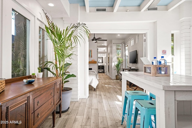 interior space with beam ceiling, light wood finished floors, recessed lighting, visible vents, and a ceiling fan