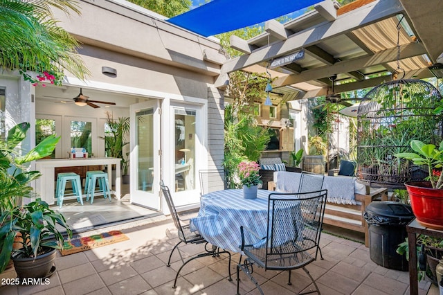 view of patio / terrace with outdoor dry bar, french doors, an outdoor living space, and a ceiling fan