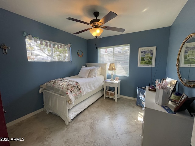 bedroom featuring a ceiling fan and baseboards