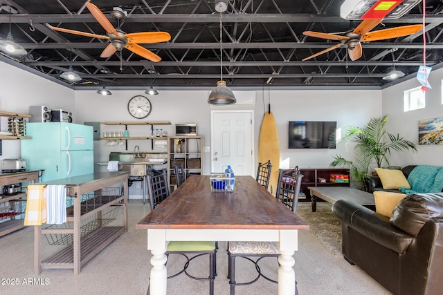 dining room with speckled floor and a ceiling fan