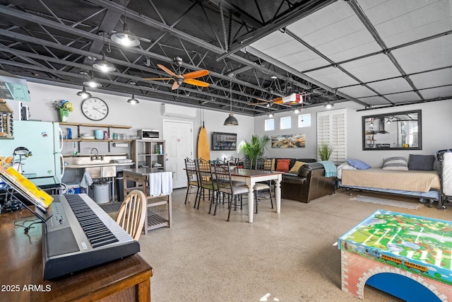 interior space featuring a wall mounted air conditioner, a sink, and speckled floor