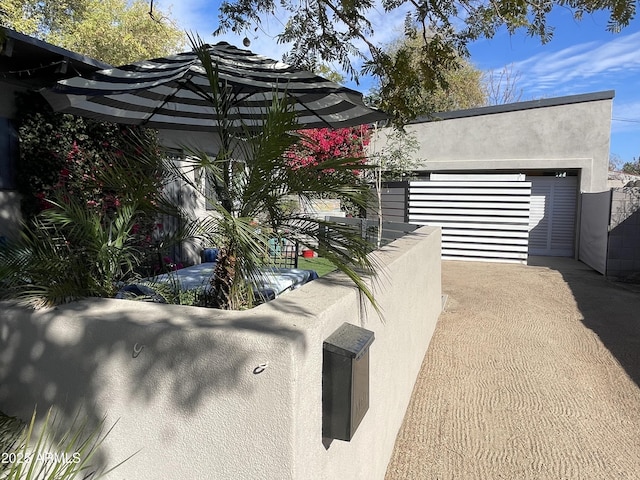 view of property exterior featuring fence and stucco siding