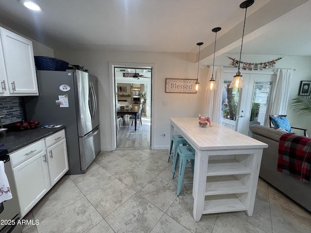 kitchen featuring decorative backsplash, dark countertops, pendant lighting, white cabinetry, and open shelves