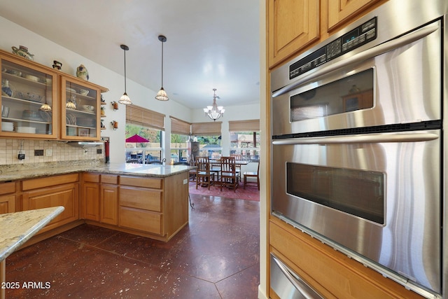 kitchen featuring hanging light fixtures, tasteful backsplash, light stone countertops, kitchen peninsula, and stainless steel double oven