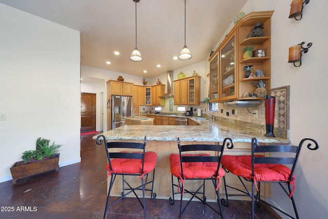 kitchen featuring backsplash, a kitchen breakfast bar, kitchen peninsula, stainless steel refrigerator with ice dispenser, and wall chimney exhaust hood