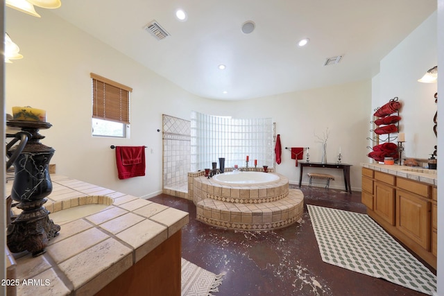 bathroom with vanity and a washtub